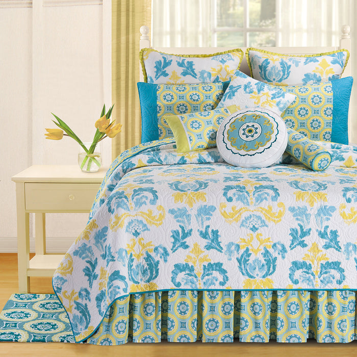 A Delilah Blue Quilt displayed on a made bed.