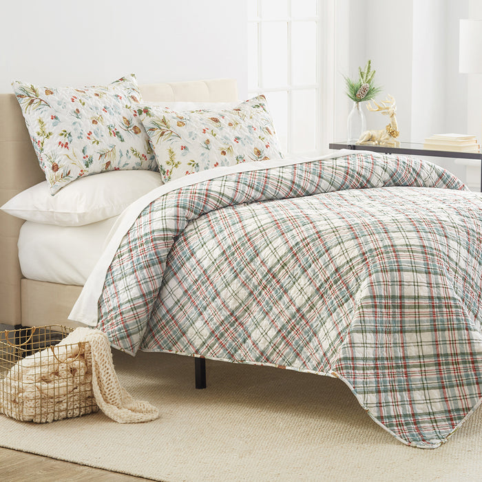 A Pinecones & Berries Quilt Set displayed on a made bed.