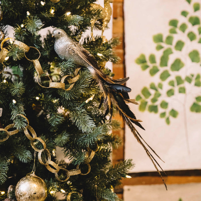 silver glitter bird ornament in tree