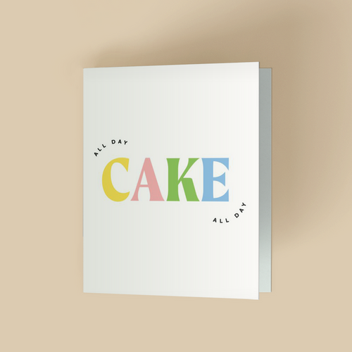 Birthday or celebration card with white background. The word "CAKE" is in large, bold, multicolor serif letters - yellow C, pink A, green K, blue E- centered. Small black sans-serif text "ALL DAY" arched above the C and below the E.