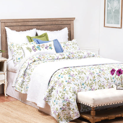 A Carley Quilt Set displayed on a made bed.