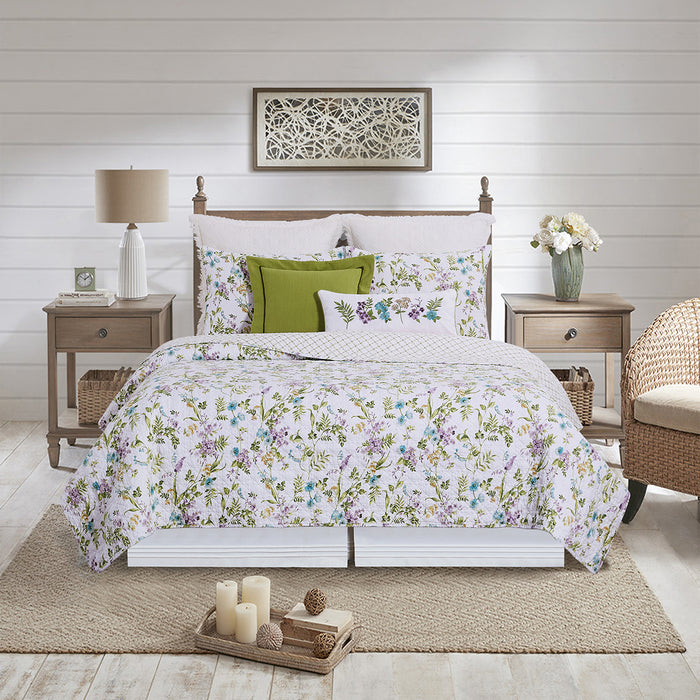 A Carley Quilt Set displayed on a made bed.