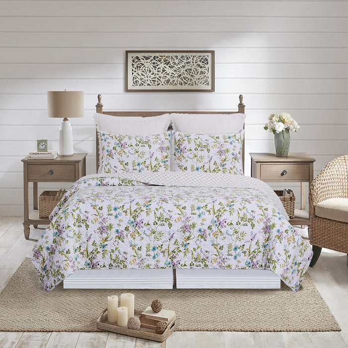 A Carley Quilt Set displayed on a made bed.