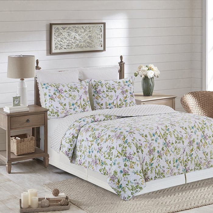 A Carley Quilt Set displayed on a made bed.