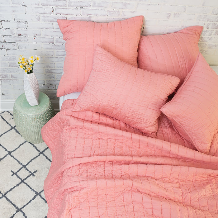 A channel stitch quilt displayed on a made bed.