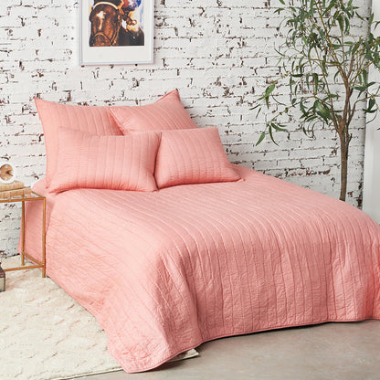 A channel stitch quilt displayed on a made bed.