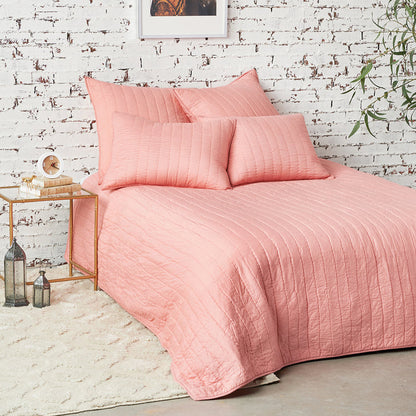A channel stitch quilt displayed on a made bed.