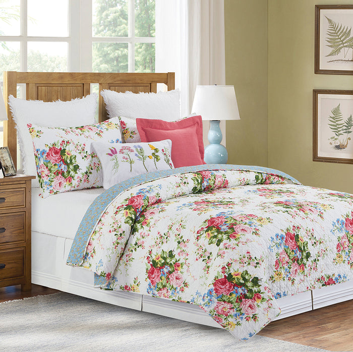 A Cottage Rose Quilt Set displayed on a made bed.