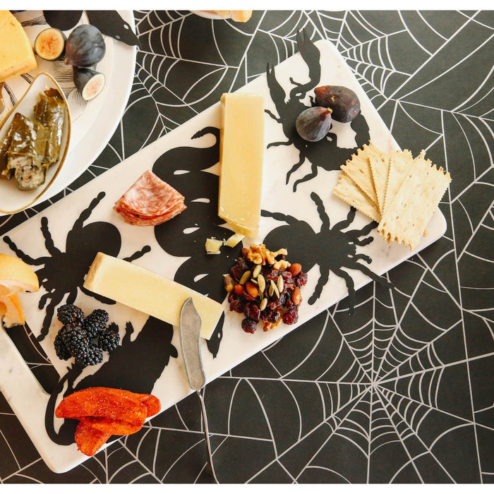 Die-cut, black paper cutouts of a rat, a snake, a spider and a scorpion.