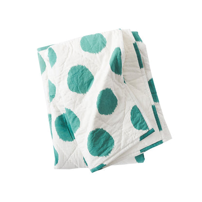 A dot pet quilt displayed on a made bed.