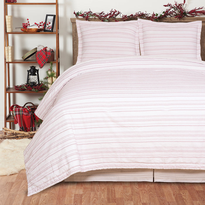 A Dotted Seersucker Quilt Set displayed on a made bed.