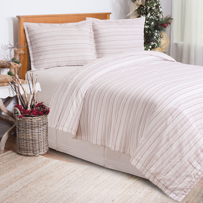 A Dotted Seersucker Quilt Set displayed on a made bed.