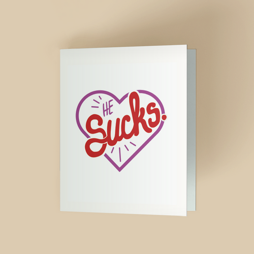 White greeting card with a purple heart outline in the center. Inside the heart, the text "HE SUCKS" is in mixed fonts- small uppercase "HE" in purple at top left, and large red retro script for "SUCKS" with small burst accent.