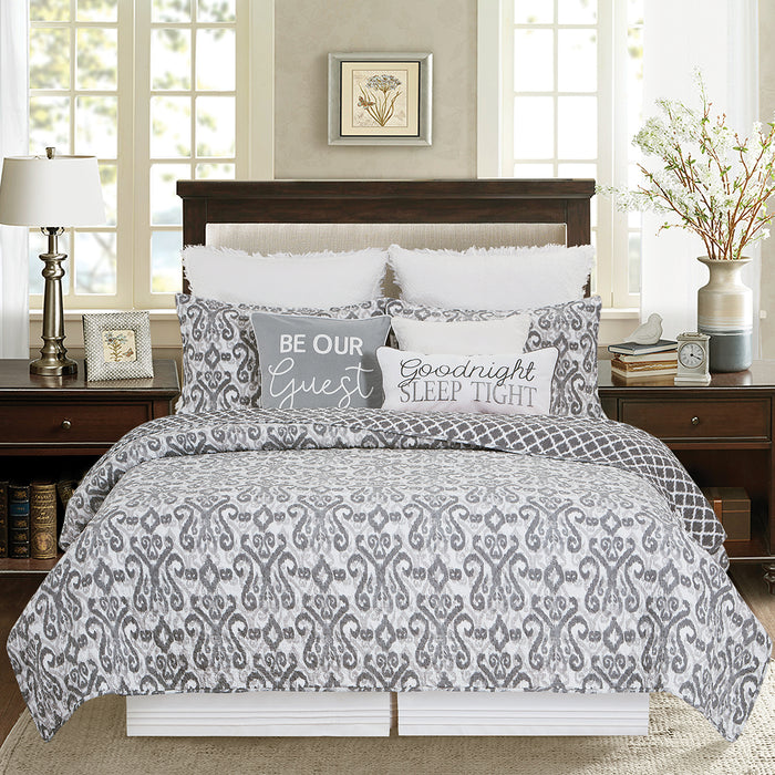 A Heather Quilt Set displayed on a made bed.