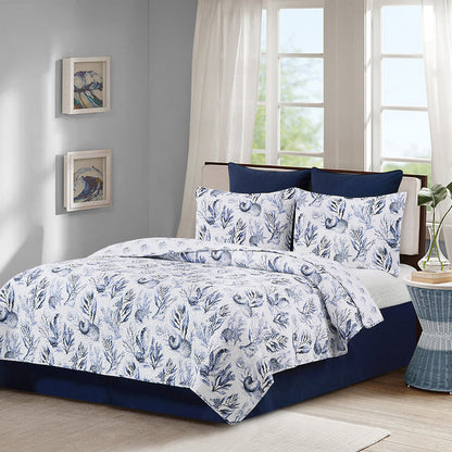 A Midnight Lagoon Quilt Set displayed on a made bed.