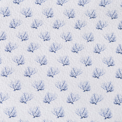 A Midnight Lagoon Quilt Set displayed on a made bed.