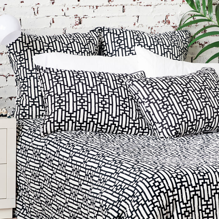 A Naya Quilt displayed on a made bed.