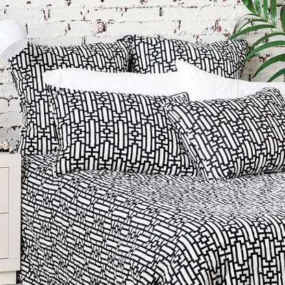 A Naya Quilt displayed on a made bed.