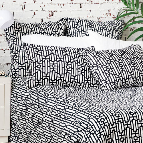 A Naya Quilt displayed on a made bed.