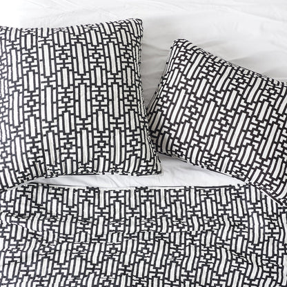 A Naya Quilt displayed on a made bed.