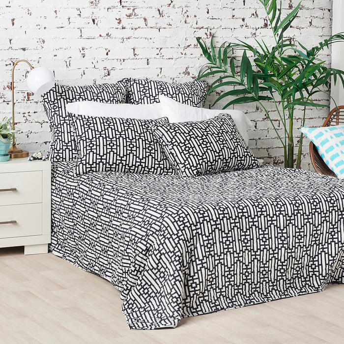 A Naya Quilt displayed on a made bed.