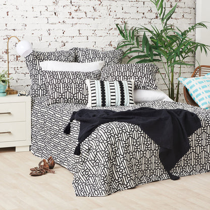 A Naya Quilt displayed on a made bed.