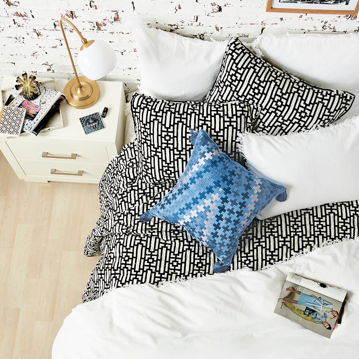 A Naya Quilt displayed on a made bed.