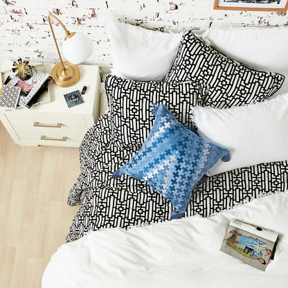 A Naya Quilt displayed on a made bed.