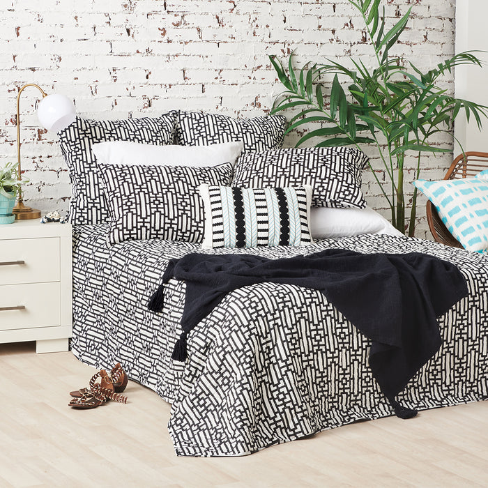 A Naya Quilt displayed on a made bed.