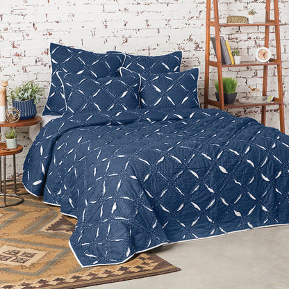 A parker indigo quilt displayed on a made bed.