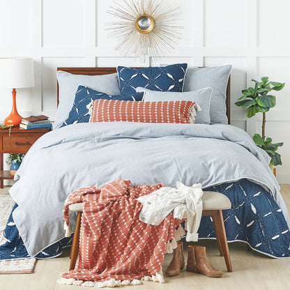 A parker indigo quilt displayed on a made bed.