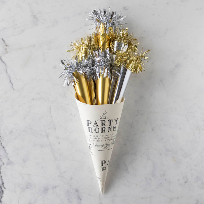 A paper cone of silver and gold party horns.