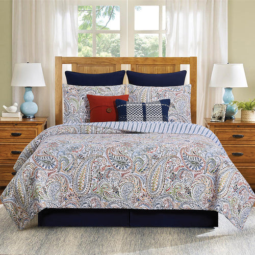 A Payton Paisley Quilt Set displayed on a made bed.