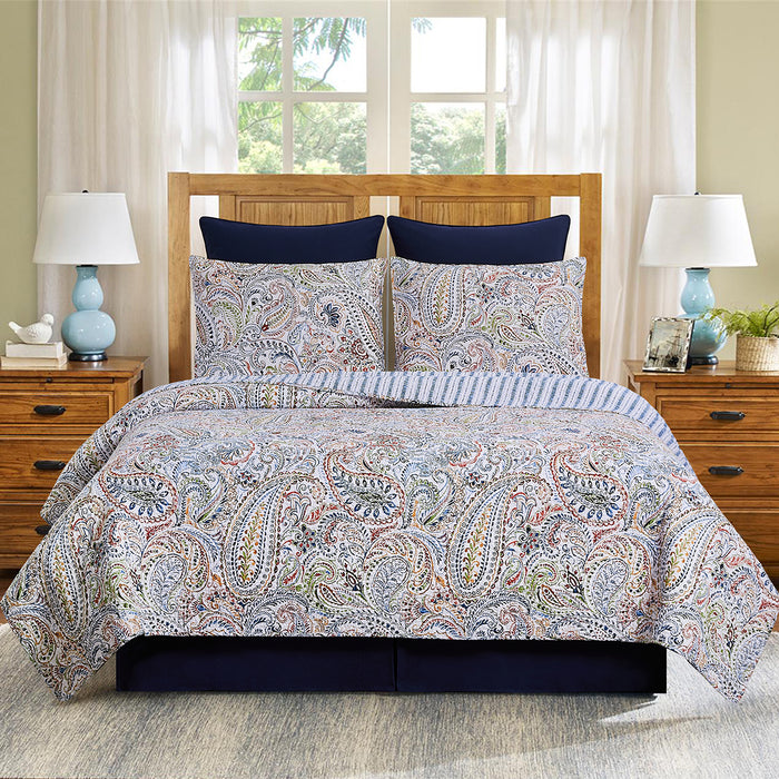 A Payton Paisley Quilt Set displayed on a made bed.
