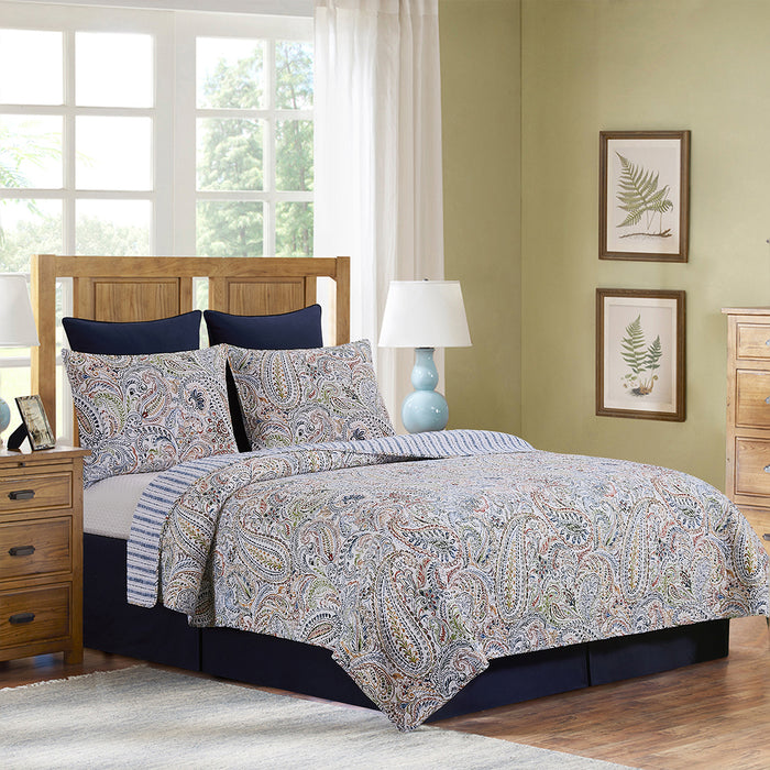 A Payton Paisley Quilt Set displayed on a made bed.