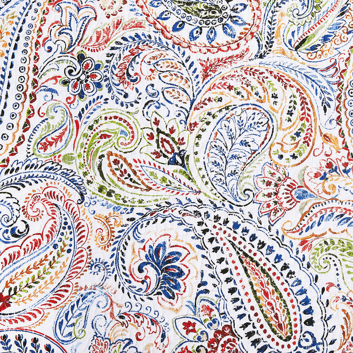 A Payton Paisley Quilt Set displayed on a made bed.