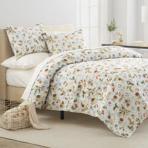 A Pinecones & Berries Quilt Set displayed on a made bed.