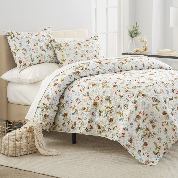 A Pinecones & Berries Quilt Set displayed on a made bed.