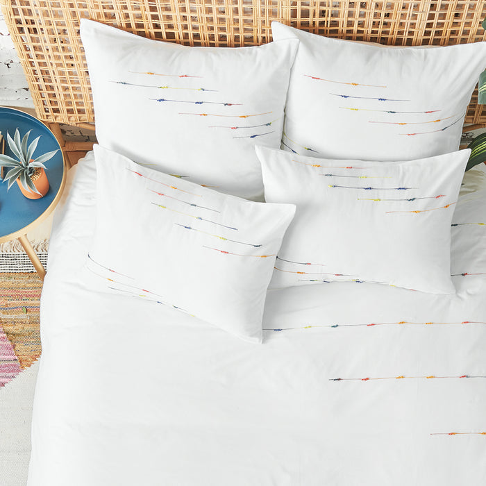A raina duvet cover displayed on a bed.