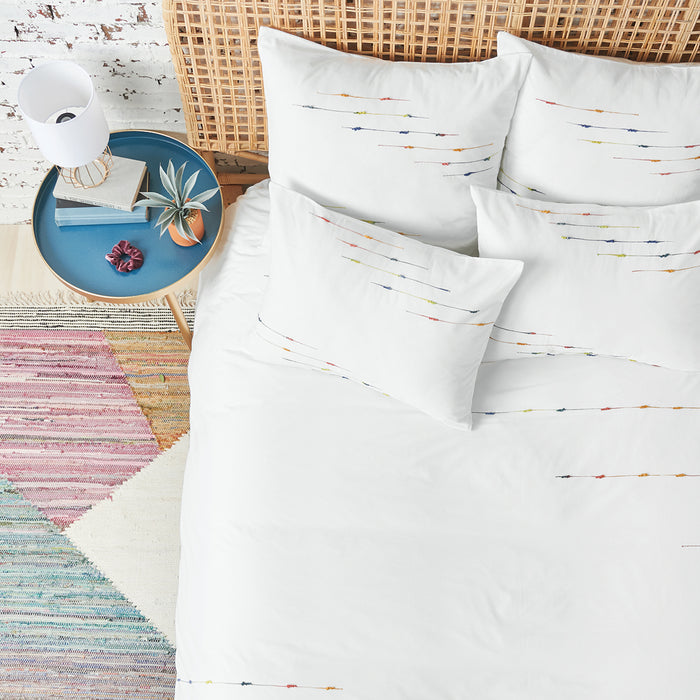 A raina duvet cover displayed on a bed.