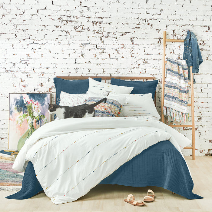A raina duvet cover displayed on a bed.
