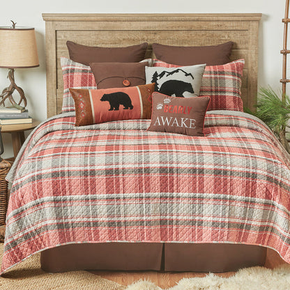 A Saffron Plaid Quilt Set displayed on a made bed.