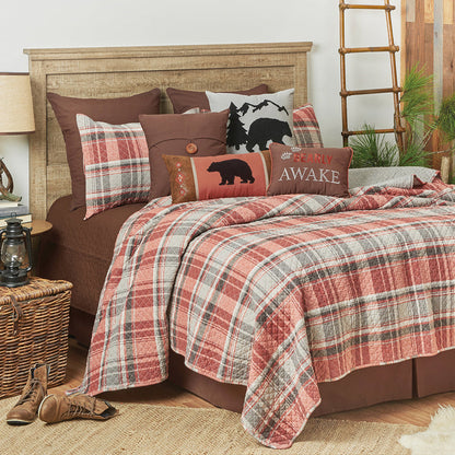 A Saffron Plaid Quilt Set displayed on a made bed.