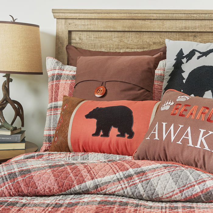 A Saffron Plaid Quilt Set displayed on a made bed.