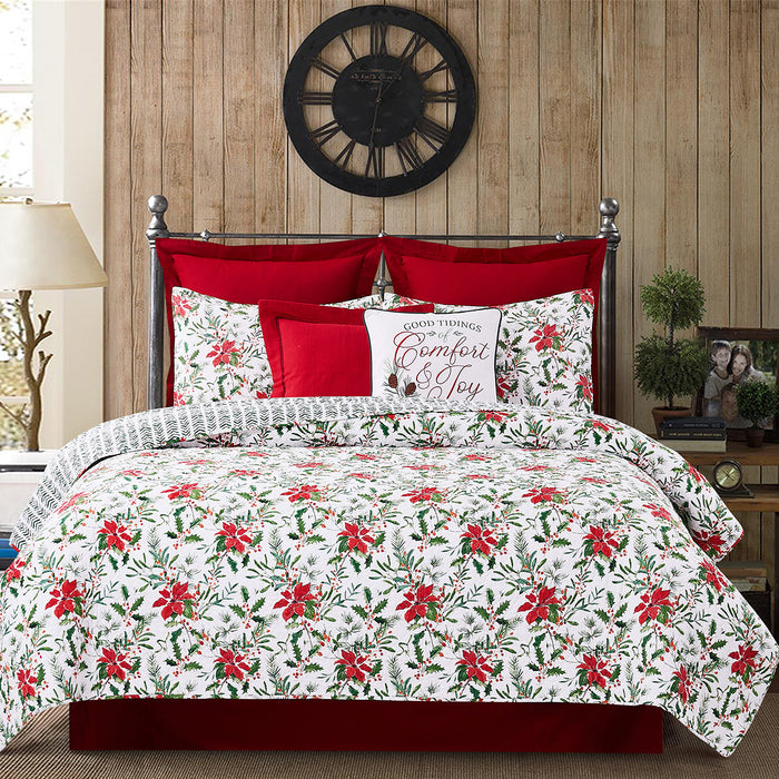 A Silvia Poinsettia Quilt Set displayed on a made bed.