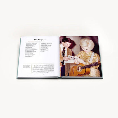 A look at the inside of the book, with the page opened to a description of a song titled "The Bridge" and a picture of young Dolly Parton with a guitar.