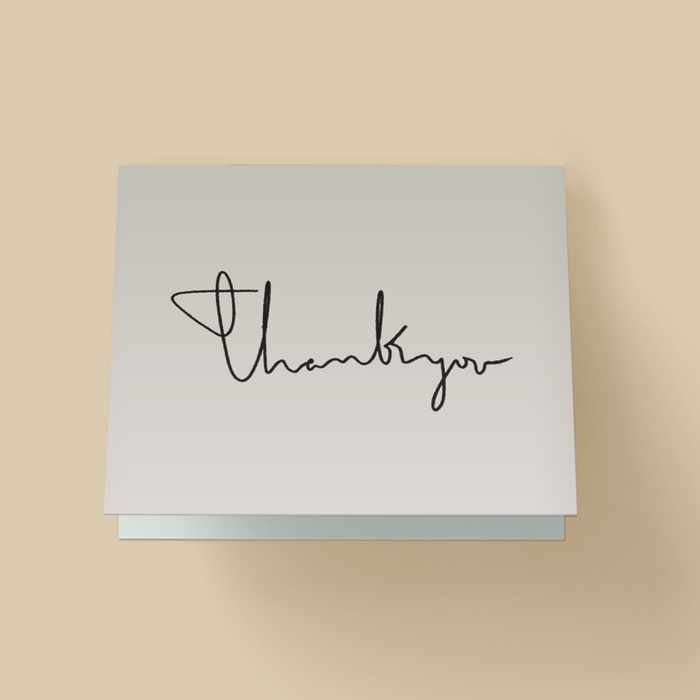Thank you card with a white background. The words 'thank you' are written in thin, black, continuous-line handwritten cursive across the center.